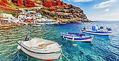 Fishing Boats In Crystal Clear Waters In Santorini, Greece