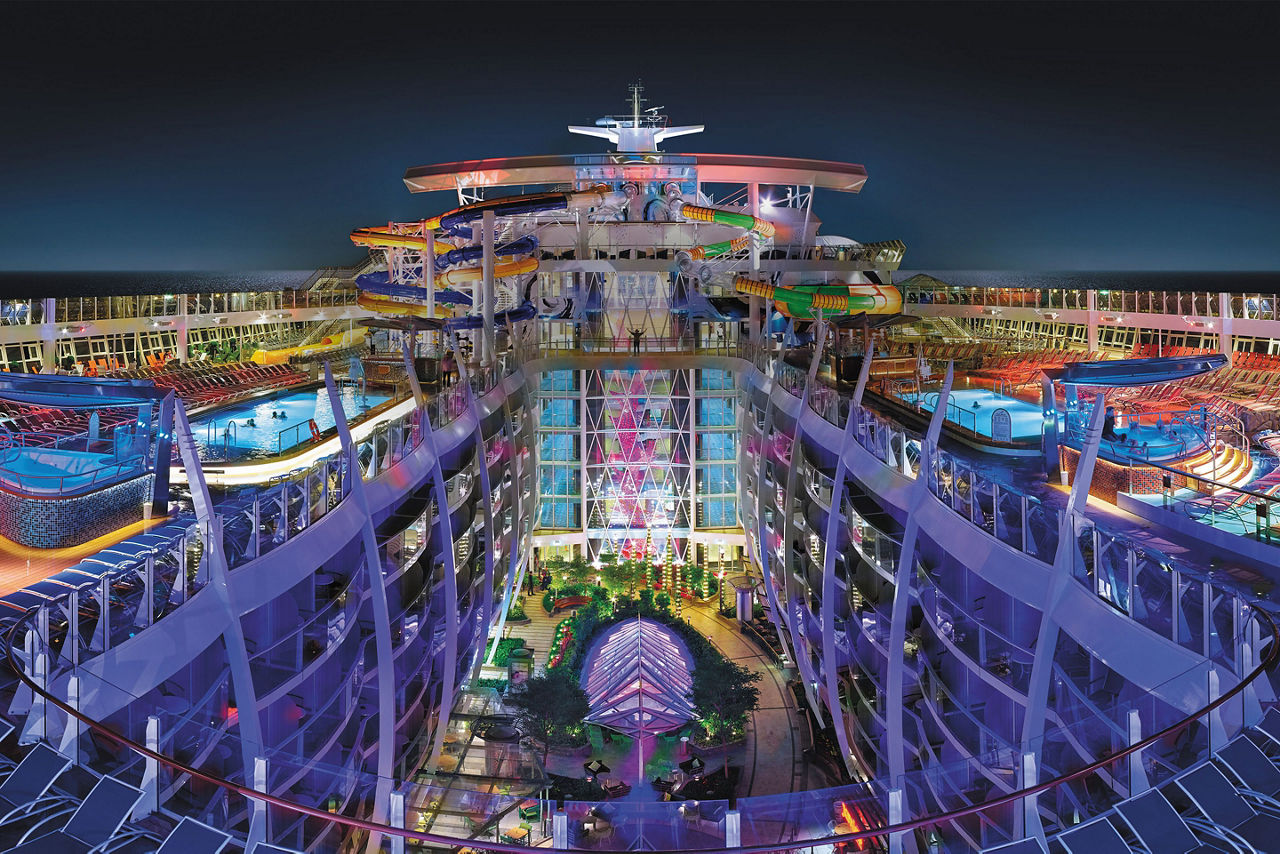 Image of Harmony of the Seas Central Park, sourced from: Royal Caribbean International https://rccl-h.assetsadobe.com/is/image/content/dam/royal/content/ship/harmony-of-the-seas/overview/hero-pic/harmony-perfect-storm-central-park-pool-deck-nightime-overview-hero-asset.jpg?$1920x800$