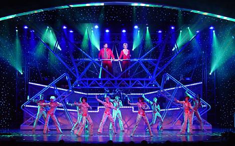 Performers in brightly lit stage during the All Access Cruise Show.