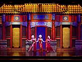 Performers in red dresses on stage during City of Dreams Cruise Show on Jewel of the Seas