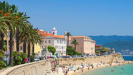 People enjoying the beach at the sea wall in Ajaccio, Corsica