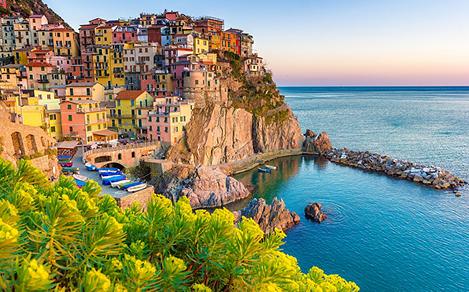 Multicolored homes lining a cliff at an Amalfi Coast city