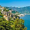 Homes lining a lush green mountain in the Amalfi Coast