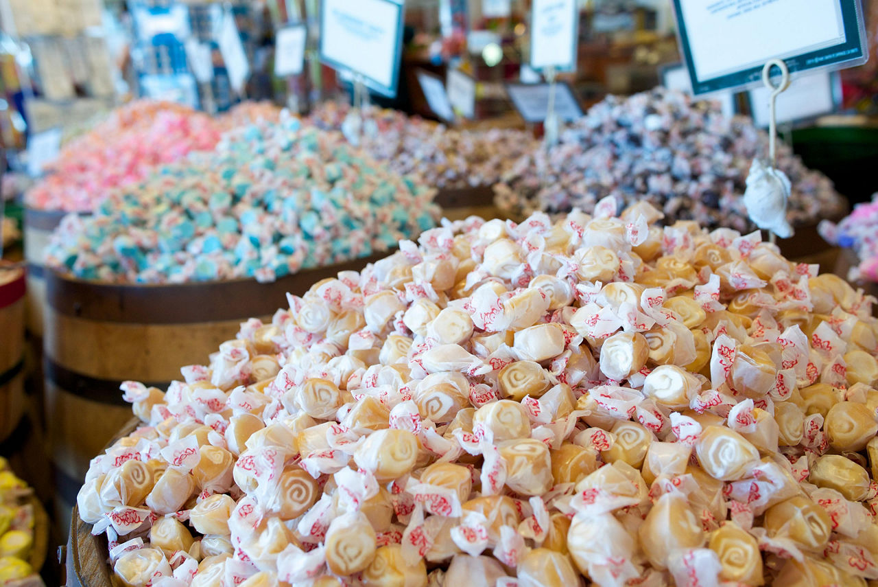 Barrels filled with various flavors of salt water taffy