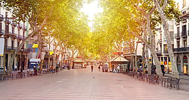 Street view of La Rambla in Barcelona, Spain, with shops lining the street