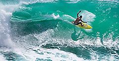 Surfer Riding a Big Wave at Padang Padang Beach, Bali, Indonesia.