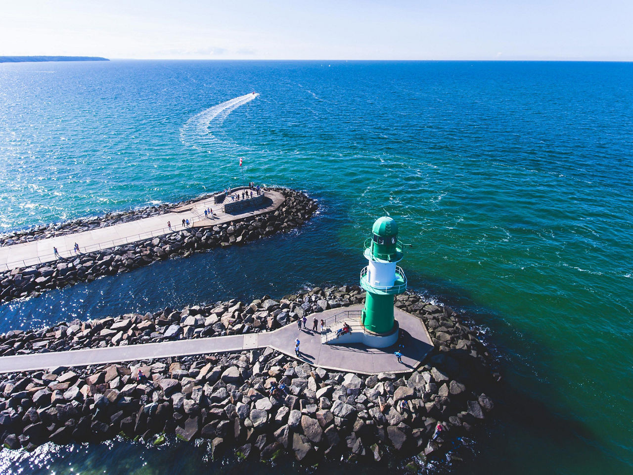 A green coastal lighthouse in Rostock, Germany