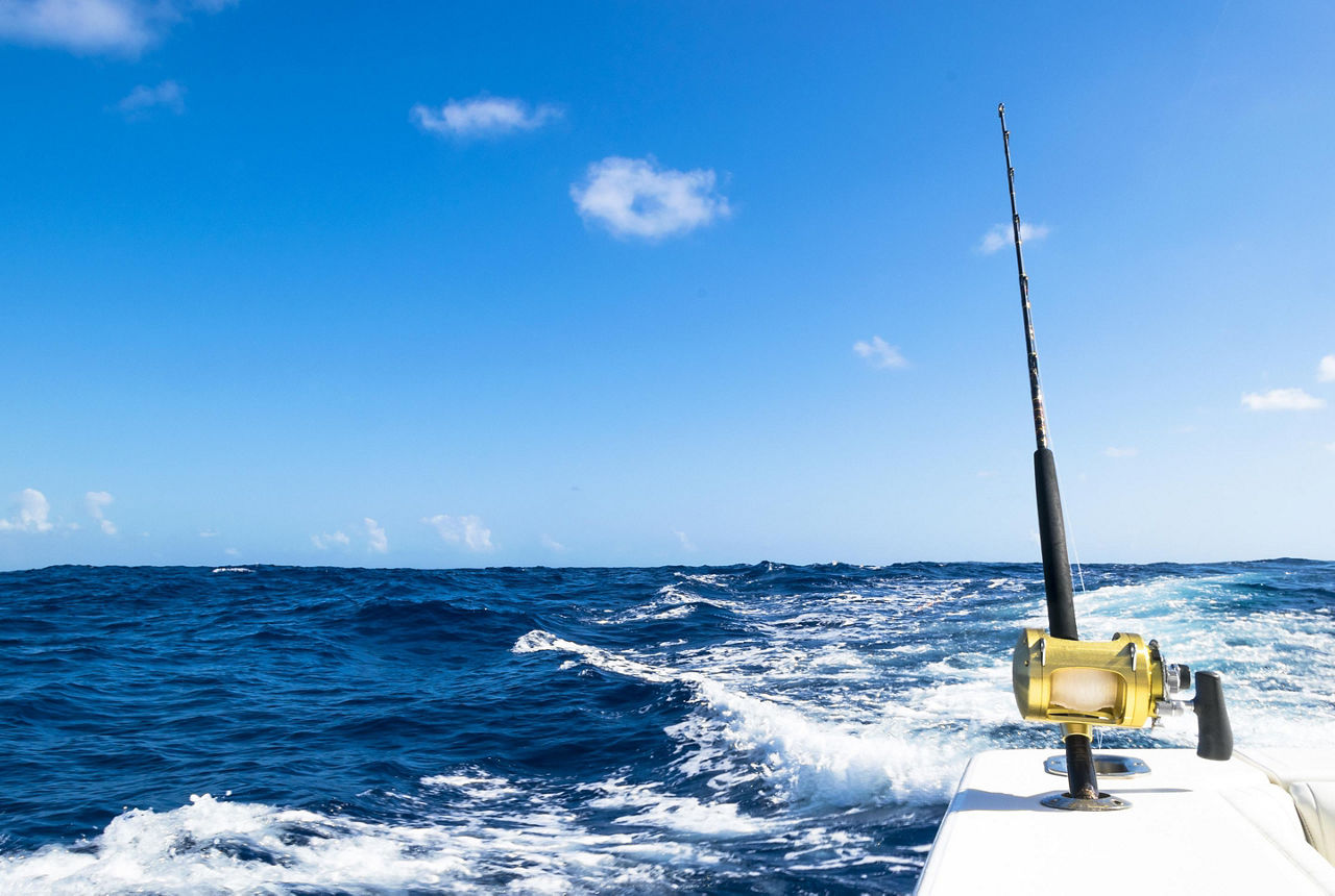 A fishing rod on a boat in the oceean