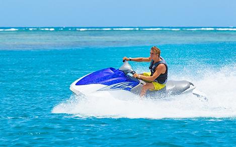 Man Riding Jet Ski in Beautiful Blue Water, Coco Cay, Bahamas