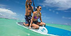 Couple Having Fun on a Paddle-board in the Water, Cozumel, Mexico 