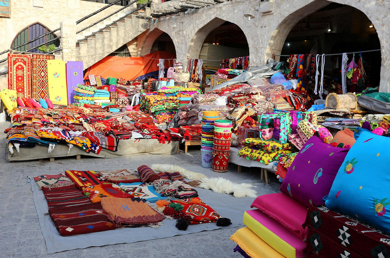 Colourful textiles on show at a shop in Souq Waqif market, Doha, Qatar