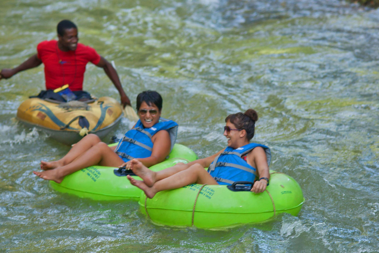 Two People Tubing Down a River with a Guide, Falmouth, Jamaica