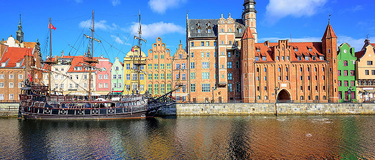 Coastal view of old town and a vintage ship in Gdansk, Poland