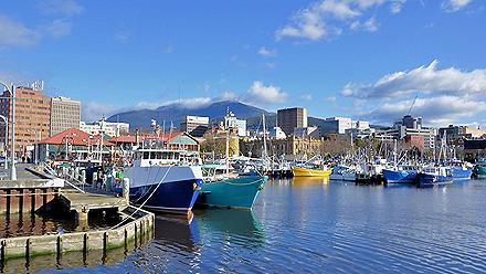 View of the harbour with colorful boats along the dock in Hobart, Tasmania