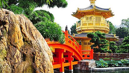 A red bridge leading to a temple Chinese architecture in a garden in Hong Kong, China