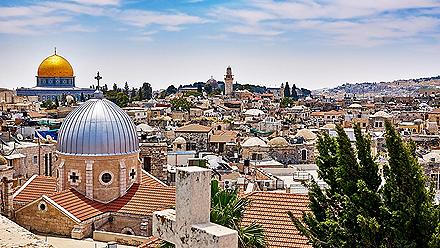A panoramic view of Jerusalem, Israel seeing the entire city with religious domes and stoned small buildings