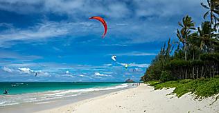 A red kite surfing on the beach of Kailua Kona, Hawaii