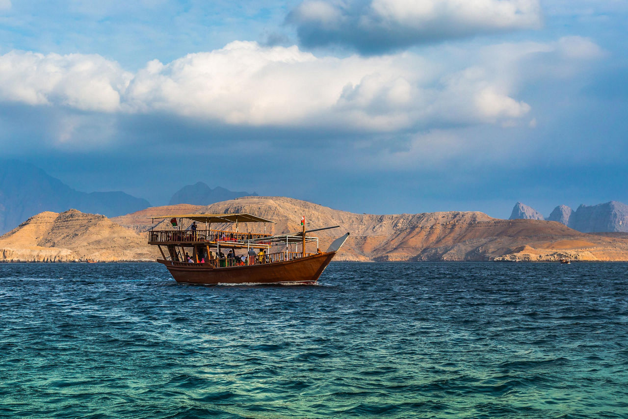 A traditional dhow boat cruising through the water