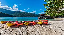 Multiple beach kayaks lined up along the shore of the beach in Labadee, Haiti
