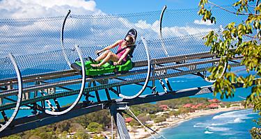 Girl riding Dragon's Tail Coaster with view of the beach, Labadee, Haiti