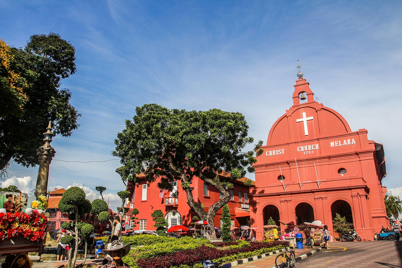 Christ Church Melaka, red church in front of a colorful park in Malacca, Malaysia