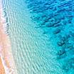 An aerial view of a crystal blue beach and shoreline in Lahaina, Maui, Hawaii
