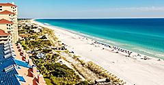 Long stretch of Miramar Beach, in Destin, Florida and the emerald green waters of the Gulf of Mexico.