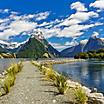 A pathway through a naturesque body of water with mountains around in New Zealand