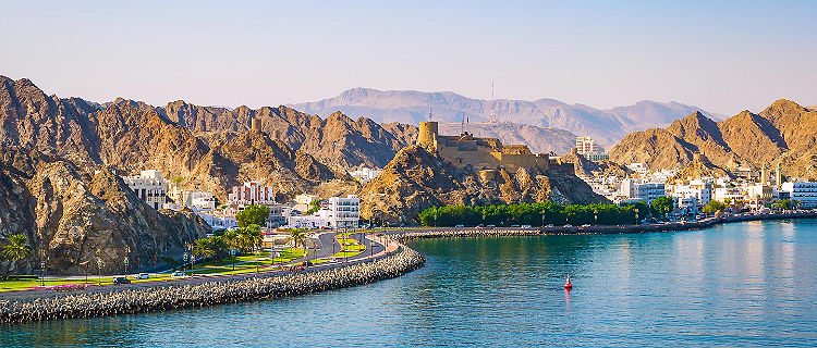 View of the waterfront coast with mountains in Muscat, Oman