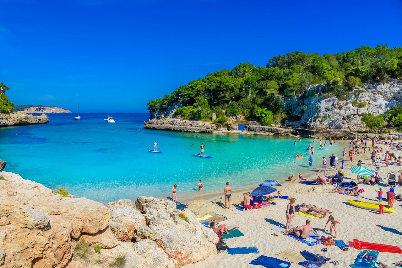 People enjoying Cala Llombards beach in Palma de Mallorca, Spain
