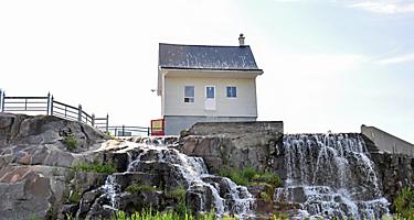 La Petite Maison Blanche, the little white house that withstood a disastrous flood and became a symbol of perseverance, in Saguenay, Quebec