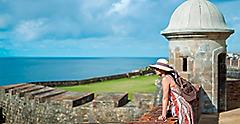 Woman Leaning on Fort El Morro to Enjoy the view, San Juan, Puerto Rico