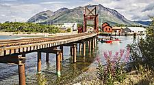 Skagway Alaska vintage train transportation rail along with sea and mountains in the background.