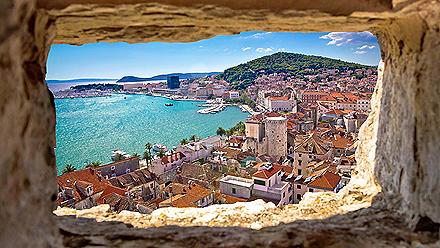 Beautiful high view of Split bay area through a stone window in Split, Croatia