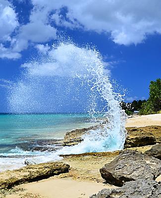 Wave Crashing Against Rocks on a Sunny Day in Frederiksted Beach, St. Croix, U.S. Virgin Islands