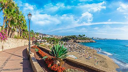 A beachfront walking path at El Duque beach in Tenerife, Canary Islands