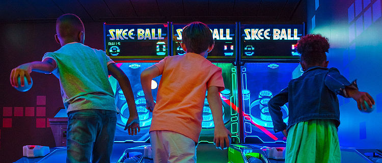 Kids Competing at Skee Ball
