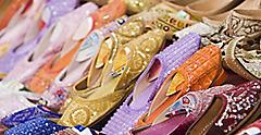 Colorful women sandals made of camel skins in street market. Dubai.