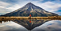 Man Standing In Front Of New Zealand Peak