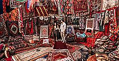 Couple standing in a rug shop to haggle. World Cruise