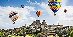 Hot air balloon ride & tourist attraction above Uchisar Castle. Turkey.