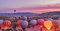 Hot air balloon riders launching tour in Turkey.