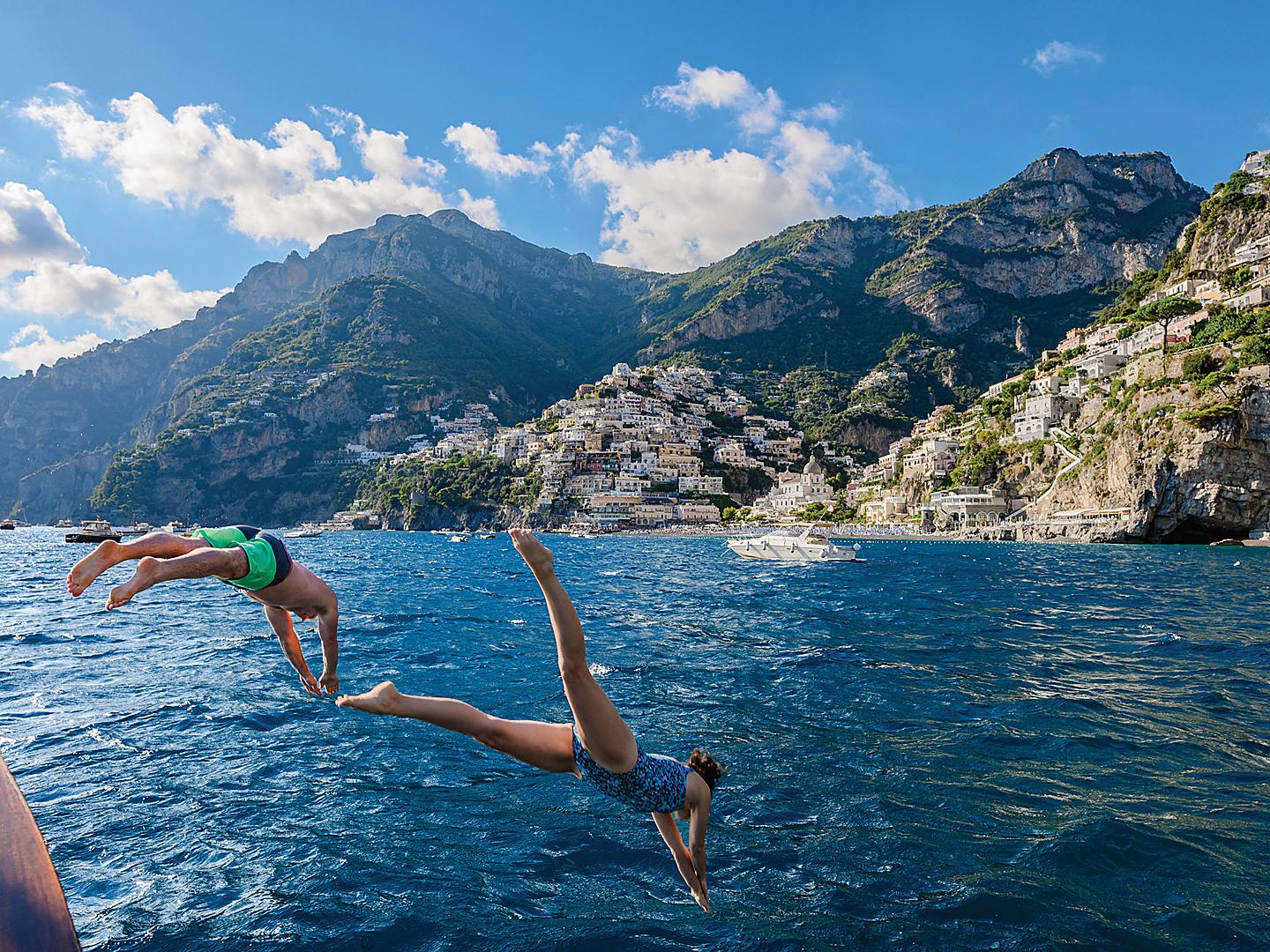 Italy Naples Positano Couple Jumping in Ocean