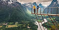 Couple standing on Rampestreken in Andalsnes. Norway.