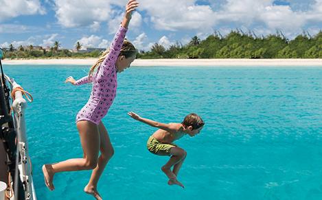 St Maarten Kids Jumping into Blue Waters