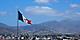 Harbor city in Ensenada with a Mexican giant waving flag. Mexico.