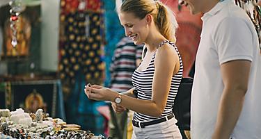 Young couple are looking at a jewellery stall in Queen Victoria Market, Australia.