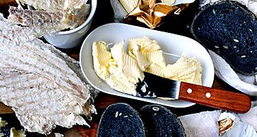 Icelandic typical dried fish (Hardfiskur) with charcoal bread and butter.