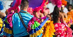 Samba dancers in colorful frilled costumes at a daytime Carnival street party in Rio de Janeiro, Brazil