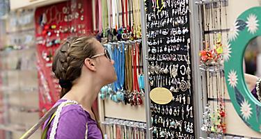The girl is choosing souvenir at a greek market, Athens